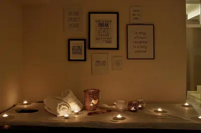 a table with candles and lights on a bed at Anita Guest House & Relax in Perushtitsa