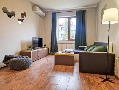 a living room with a couch and a table at Charming Mont Blanc Bansko Apartment Near Ski Lift by Flat Mаnager in Bansko