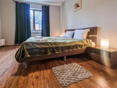 a bedroom with a large bed and a window at Charming Mont Blanc Bansko Apartment Near Ski Lift by Flat Mаnager in Bansko
