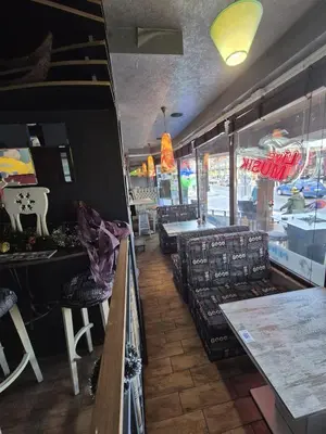 a restaurant with tables and chairs and a restaurant with a menu at Ski Lift Apartment - FORTUNA in Bansko