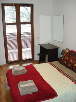 a bedroom with a bed with two towels on it at Bansko holiday apartments - Mountain View Resort in Bansko