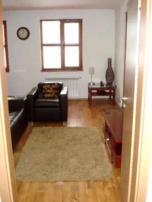 a living room with a couch and a table at Bansko holiday apartments - Mountain View Resort in Bansko