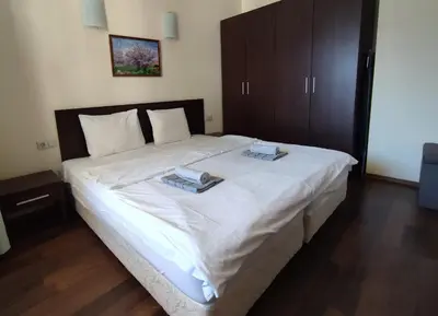 a bedroom with a large bed with two trays on it at Aspen Apartment A409 3OOm from Gondola in Bansko