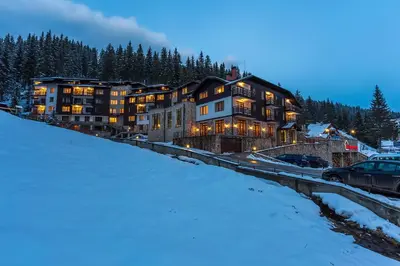 a large house on a hill in the snow at Forest Dreams in Pamporovo
