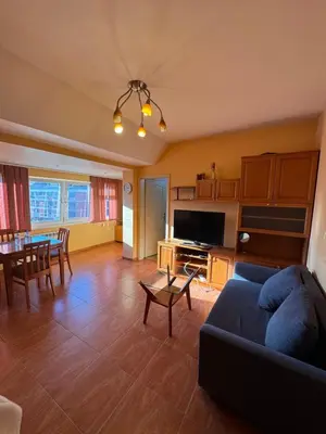 a living room with a couch and a table at Mall Bulgaria Apartment in Sofia