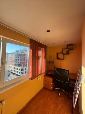 an office with a chair and a desk and a window at Mall Bulgaria Apartment in Sofia