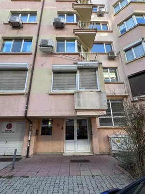 a tallartment building with windows and a door at Mall Bulgaria Apartment in Sofia