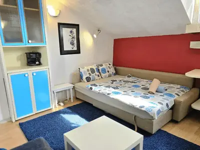 a bedroom with a bed and a red wall at The Little Pearl of Sofia in Sofia