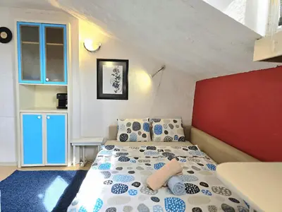 a bedroom with a bed with blue and white pillows at The Little Pearl of Sofia in Sofia