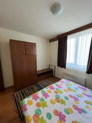 a bedroom with a bed and a dresser at Edelweiss Apartment in Bansko