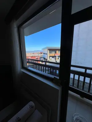 a window in a room with a view of a city at Edelweiss Apartment in Bansko