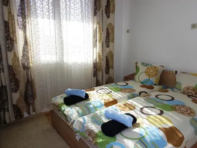 a bedroom with a bed with blue pillows on it at ViBo Guesthouse in Sapareva Banya