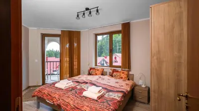 a bedroom with a bed with two towels on it at Penthouse Astralis - Pamporovo in Pamporovo