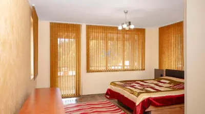 a bedroom with a bed and two windows at Penthouse Astralis - Pamporovo in Pamporovo