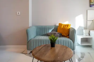 a green couch with a table in a living room at Luxury Studios in Top Center in Sofia