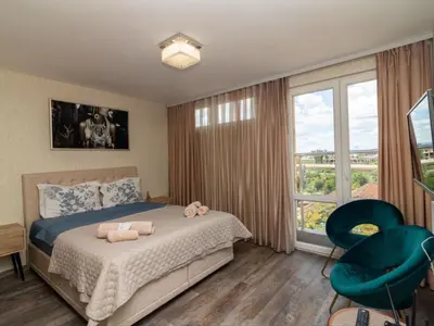 a bedroom with a bed with two stuffed animals on it at MezonetCentre in Sofia