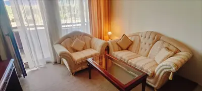 two chairs and a coffee table in a living room at Downtown Resort Bansko- Eliko Suite in Bansko