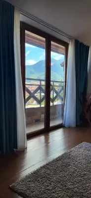 a room with a large glass door with a view at Banderitsa Hotel and Casino in Bansko