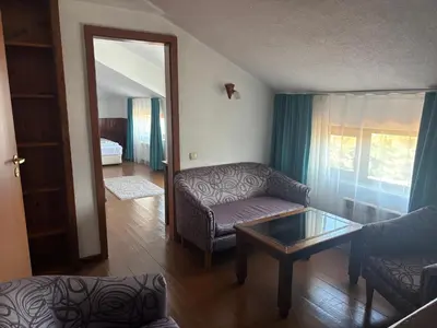 a living room with a couch and a coffee table at Banderitsa Hotel and Casino in Bansko