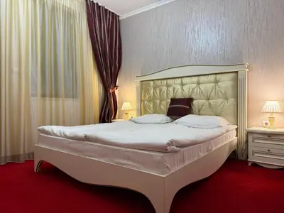 a bedroom with a large white bed in a room at Pamporovo Grand Monastery Apartment in Pamporovo