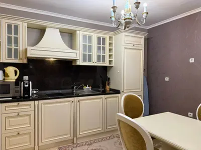 a kitchen with white cabinets and a white table at Pamporovo Grand Monastery Apartment in Pamporovo