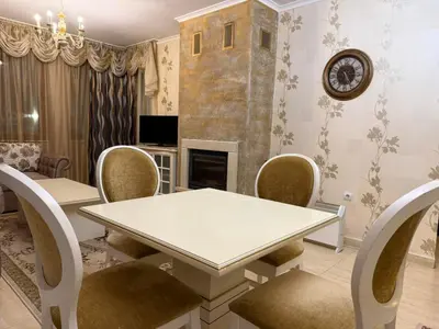 a dining room with a table and chairs and a fireplace at Pamporovo Grand Monastery Apartment in Pamporovo