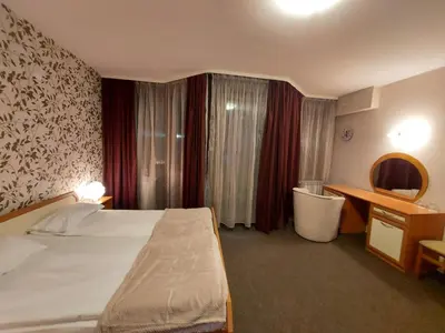 a hotel room with a bed and a desk at Ski Studio Hotel Iceberg in Borovets