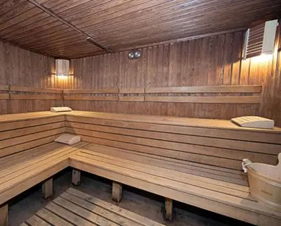 a large wooden sauna with wooden benches in at Ski Studio Hotel Iceberg in Borovets