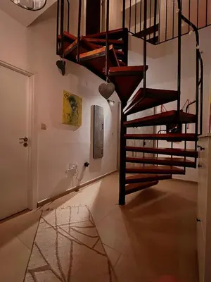 a spiral staircase in a room with a floor at CozyHomes in Bansko