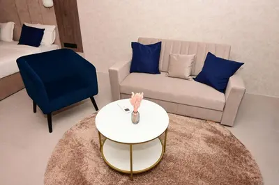 a living room with a couch and a table at Луксозни делукс стаи Мечката in Botevgrad