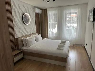 a bedroom with a bed and a large window at MonarX Suites 1113 in Bansko
