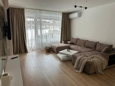 a living room with a couch and a table at MonarX Suites 1113 in Bansko