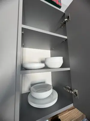 a cabinet with two bowls and plates in it at Mountain view Lux Apartment in Bansko