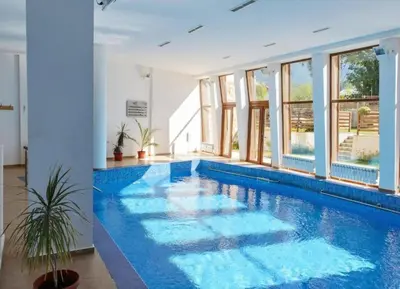 a swimming pool with blue water in a house at Mountain view Lux Apartment in Bansko