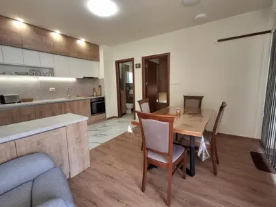 a kitchen and dining room with a table and chairs at Woodsy views 1 bedroom apartment in Bansko