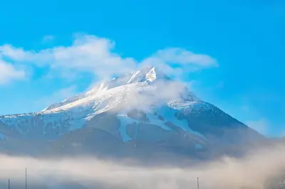 a mountain covered in snow and clouds at Орбелус in Bansko