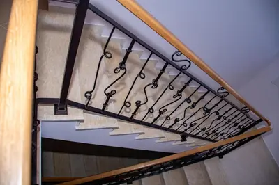 a set of stairs with wrought iron railings at Орбелус in Bansko