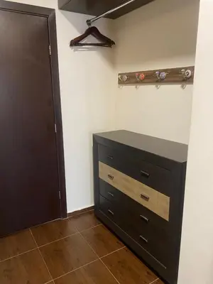a bedroom with a dresser and a closet at Royal Towers Bansko Apartment - Gondola in Bansko