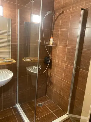 a shower with a glass door in a bathroom at Royal Towers Bansko Apartment - Gondola in Bansko