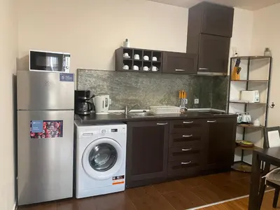 a kitchen with a refrigerator and a washing machine at Royal Towers Bansko Apartment - Gondola in Bansko