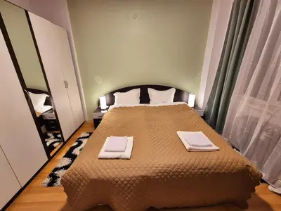 a bedroom with a bed with two towels on it at Botev's Finest 3BR in Sofia