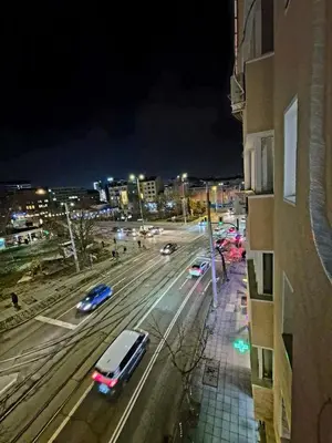 a city street at night with cars on the road at Botev's Finest 3BR in Sofia