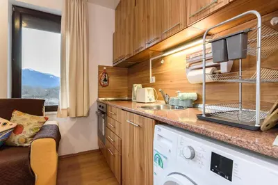 a kitchen with a sink and a dishwasher at Niki's cosy place in Bansko