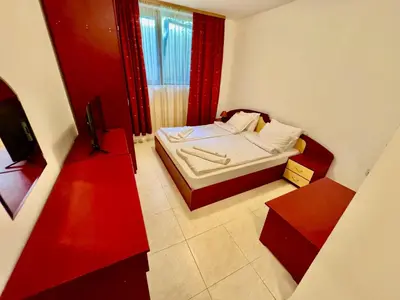 a small room with a bed and a television at Basment Rooms - Todorini Kuli in Bansko