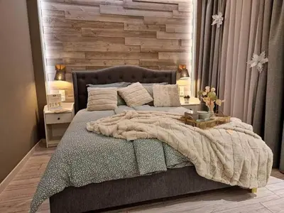 a bedroom with a large bed with a wooden wall at Luxuriously furnished and cozy studio - Magnolia in Borovets