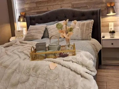 a bed with a basket of flowers on it at Luxuriously furnished and cozy studio - Magnolia in Borovets
