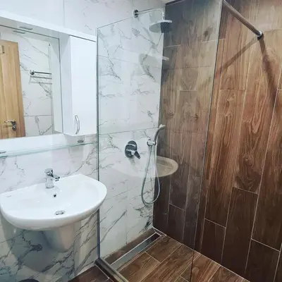 a bathroom with a sink and a glass shower at Luxuriously furnished and cozy studio - Magnolia in Borovets