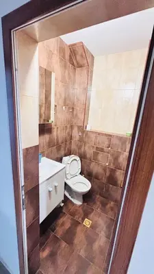 a bathroom with a toilet and a sink at Cozy Suite Vitosha street Center in Sofia