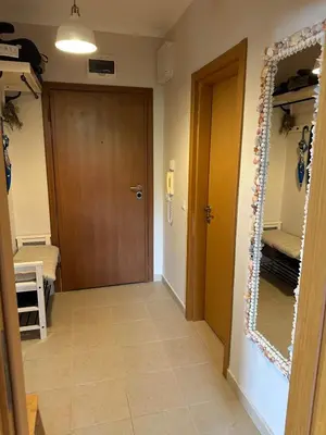 a hallway with a door and a mirror on the wall at Pravets Lake Home away from home in Pravets