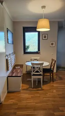 a kitchen and dining room with a table and chairs at Pravets Lake Home away from home in Pravets